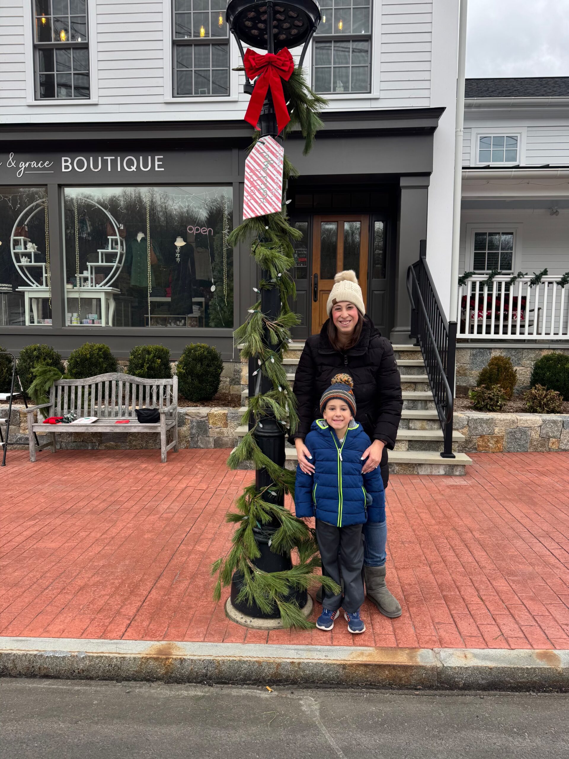 Family putting up lamppost decorations 2025 Adopt a lamppost in Sandy Hook, CT